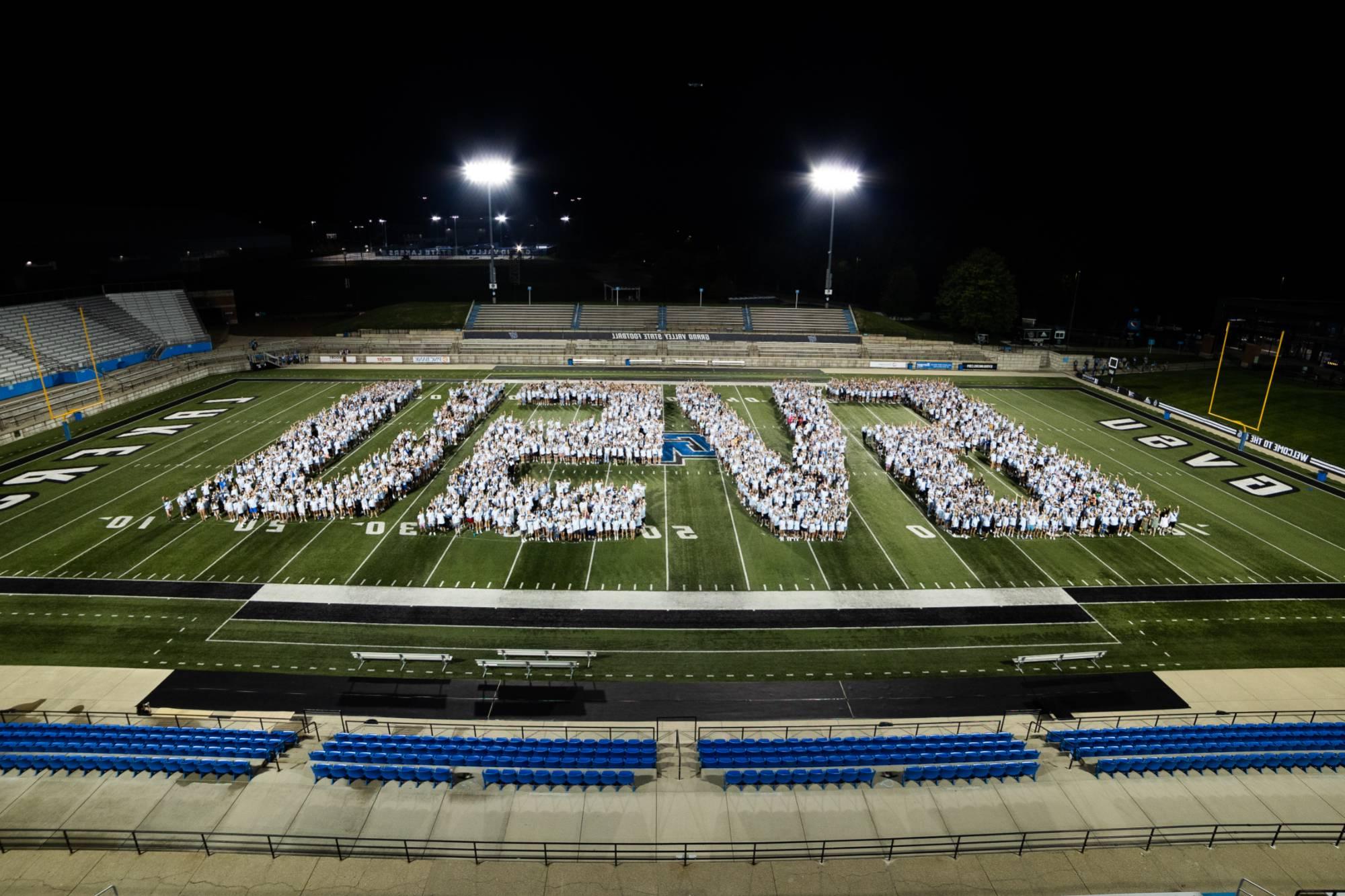 Class of 2026 class photo - students assembled on the football field to form the shape of the GVSU letters